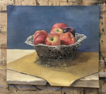 Still life painting of apples in a silver basket